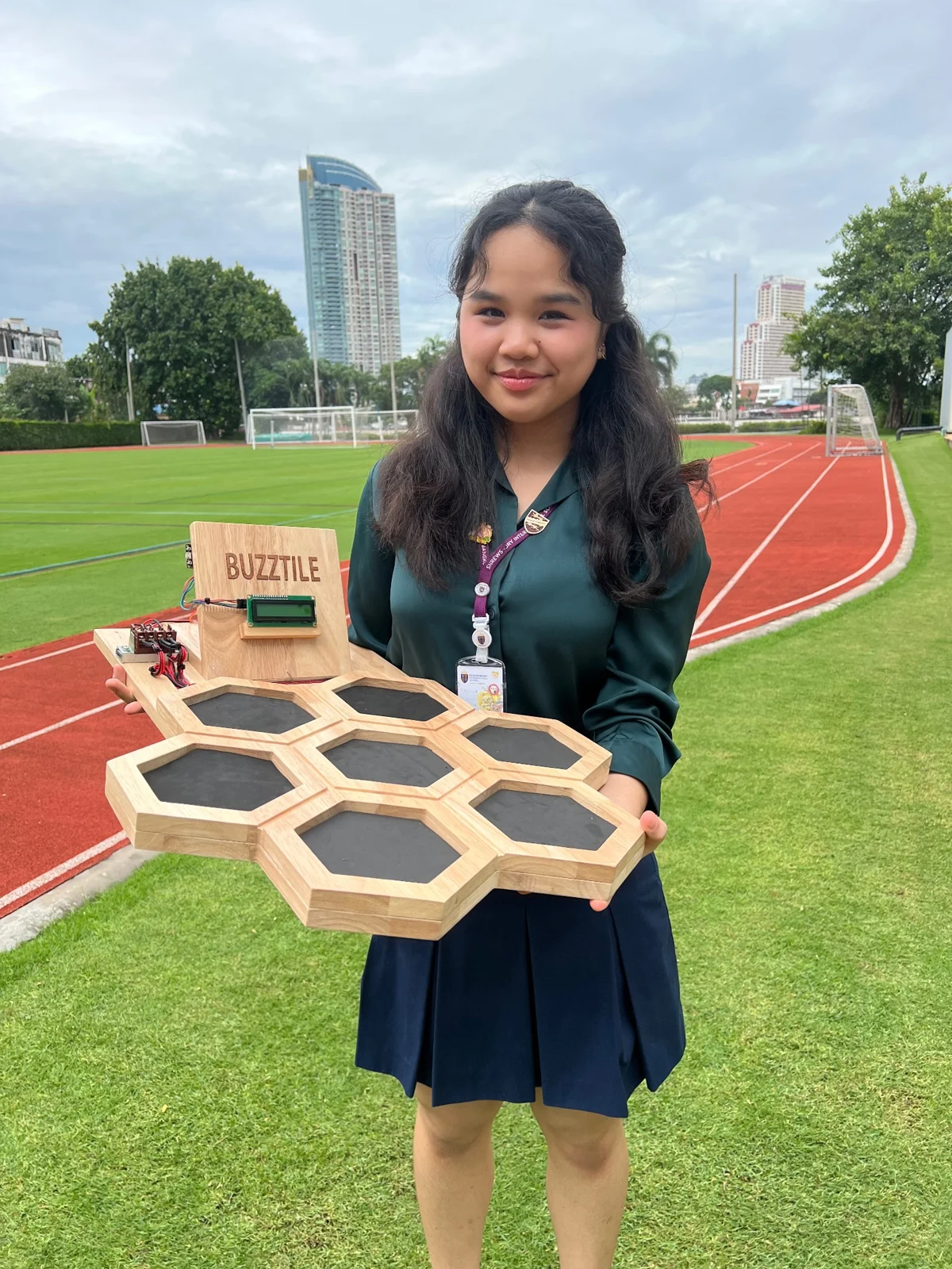 Bua holding the BuzzTile prototype