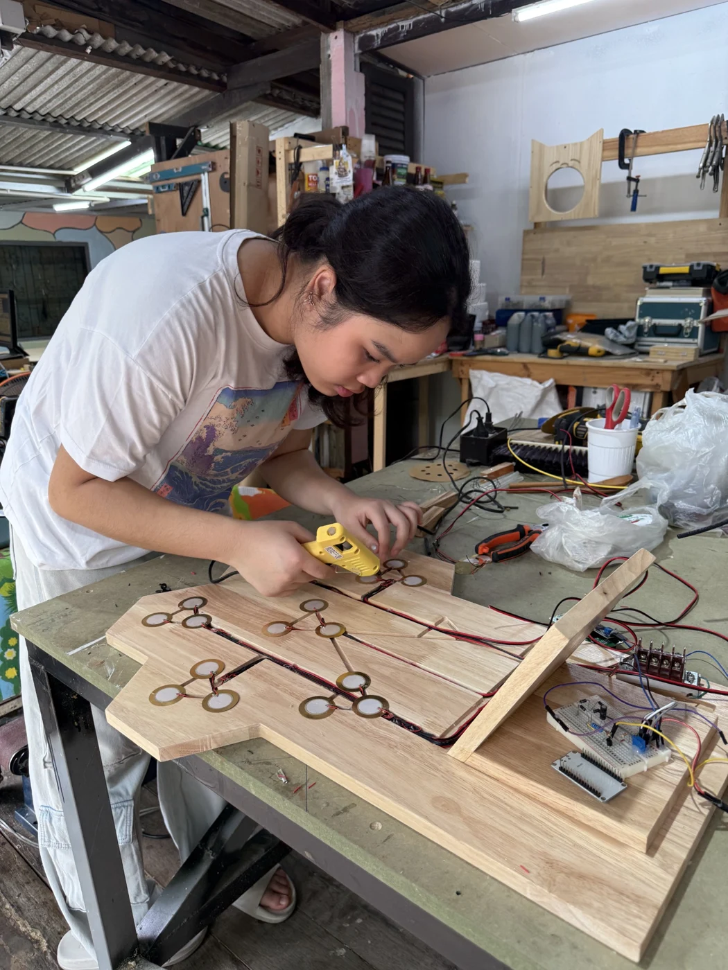 Working on a wooden design in a workshop
