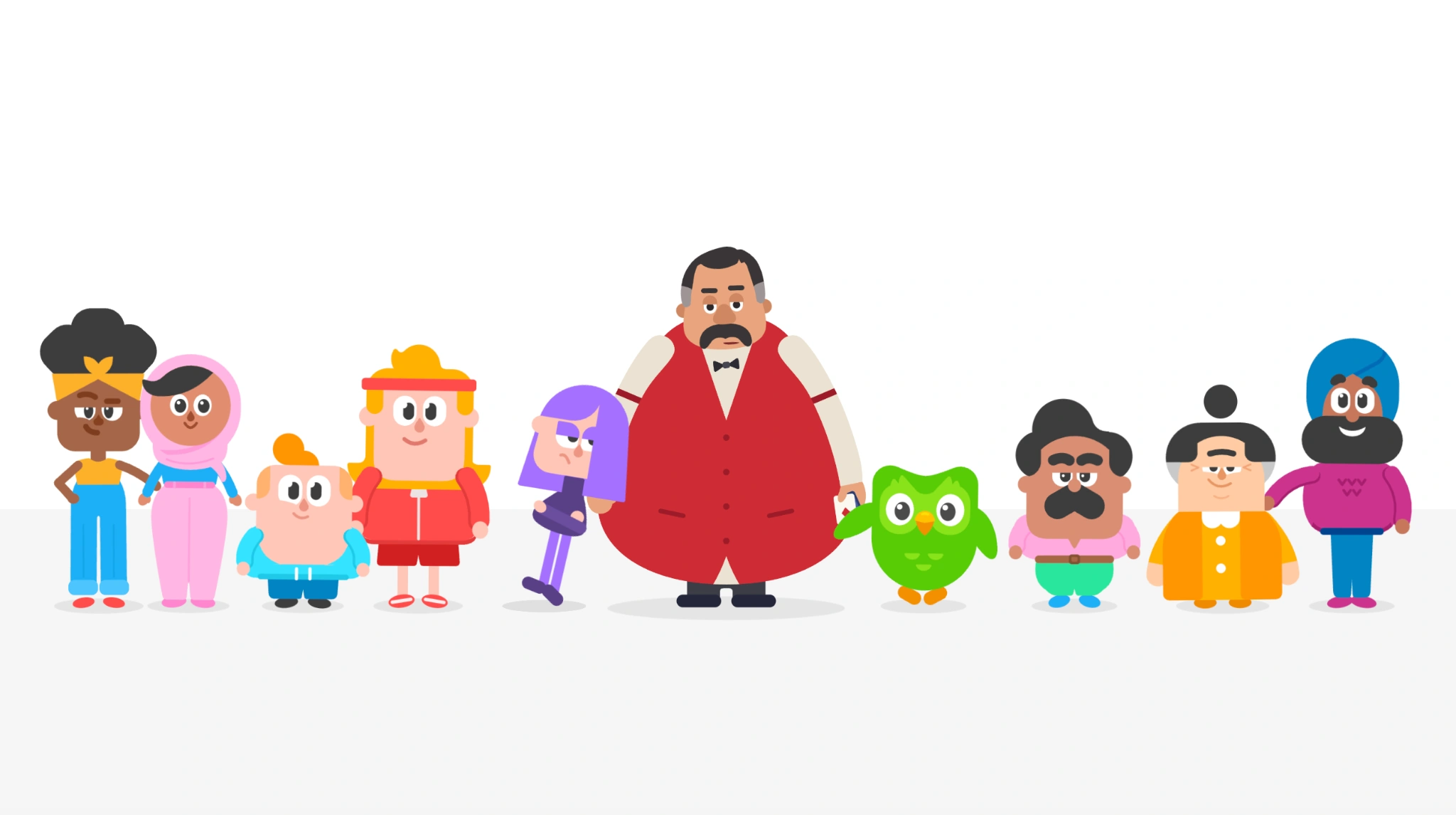 Tony standing alongside Duo and the Duolingo character family