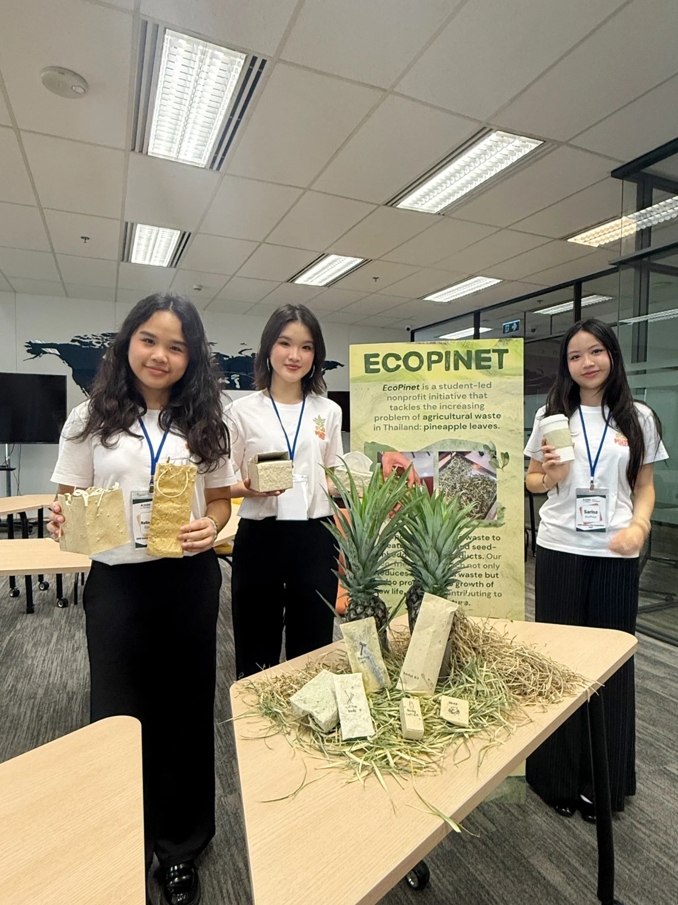 EcoPinet team with a display